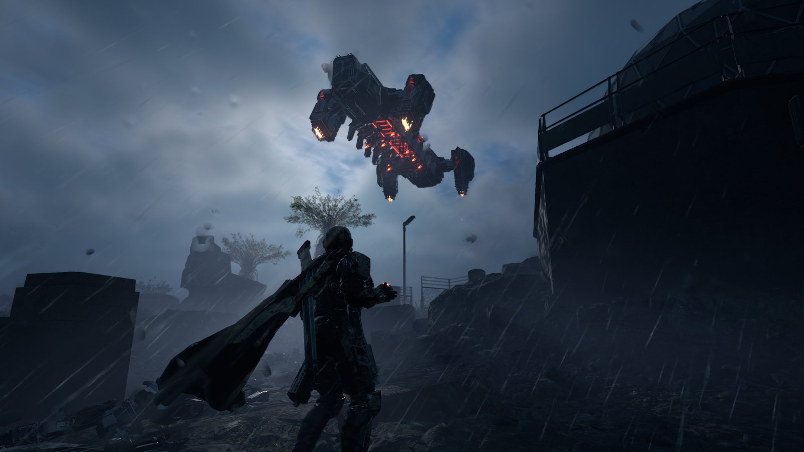 An Automaton dropship with glowing red engines flies low over a lone Helldiver in driving rain