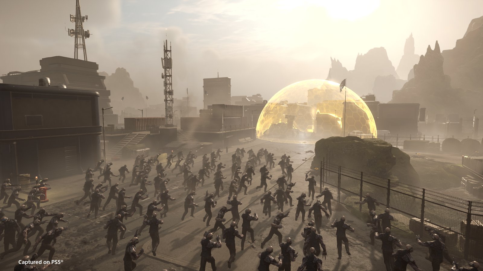 A horde of Voteless runs down a colony street toward a golden hexagonal energy dome under a hazy sky