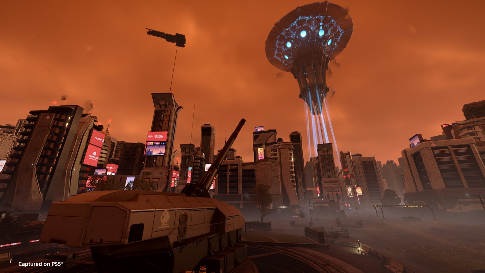 A huge jellyfish-shaped Illuminate ship with glowing blue lights hovers over city towers under an orange sky, a large city cannon in the foreground