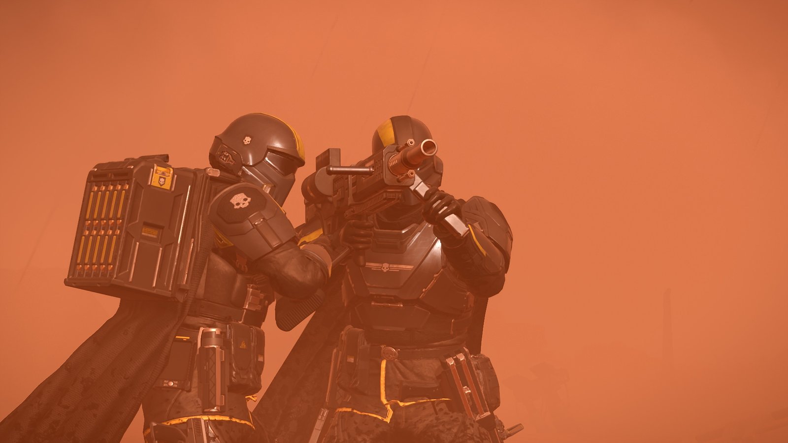 Two Helldivers working a backpack-fed launcher together