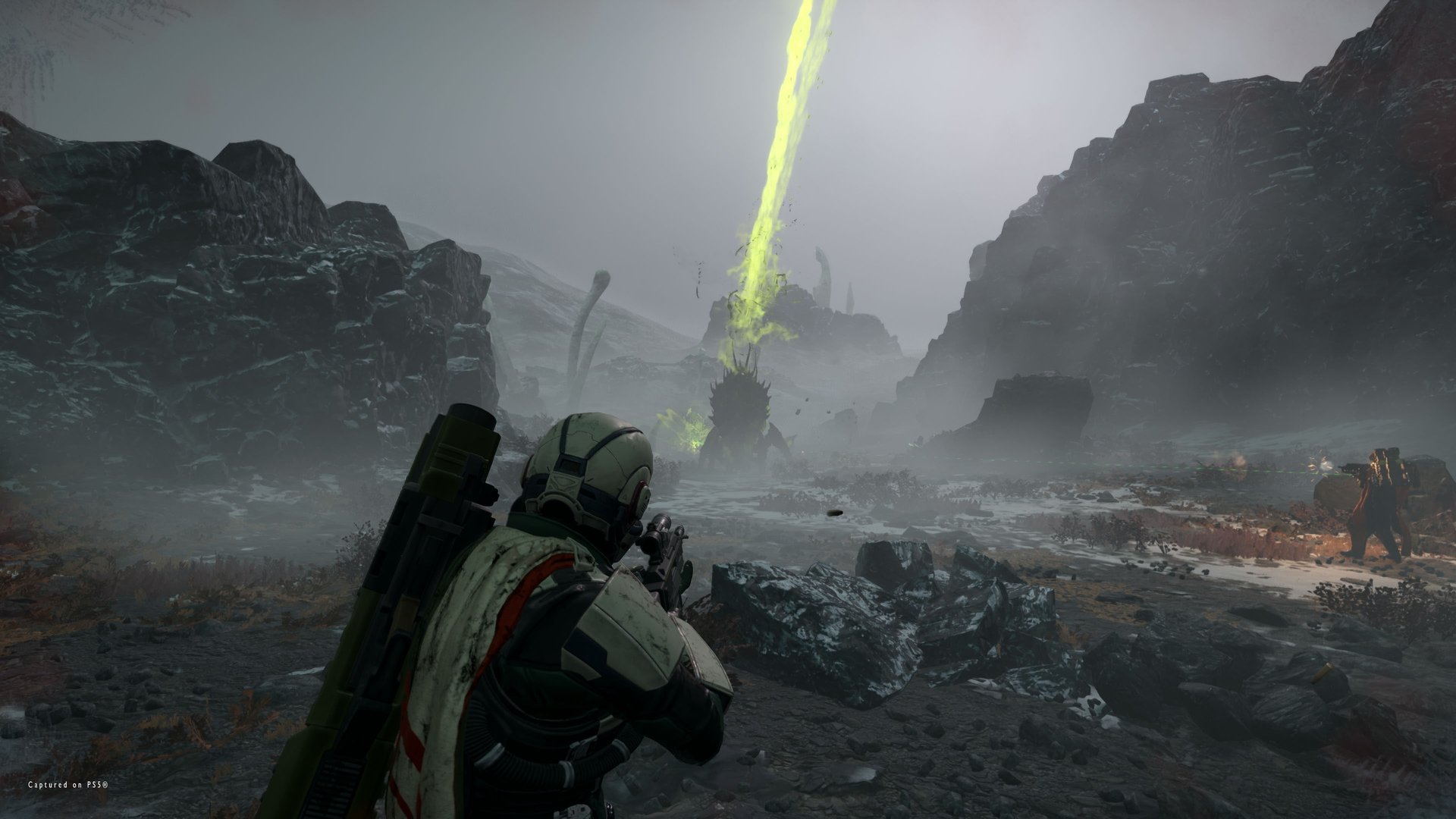 A Helldiver with a launcher slung on the back aims a rifle at a spiked Terminid while a stratagem beam rises behind it in the fog