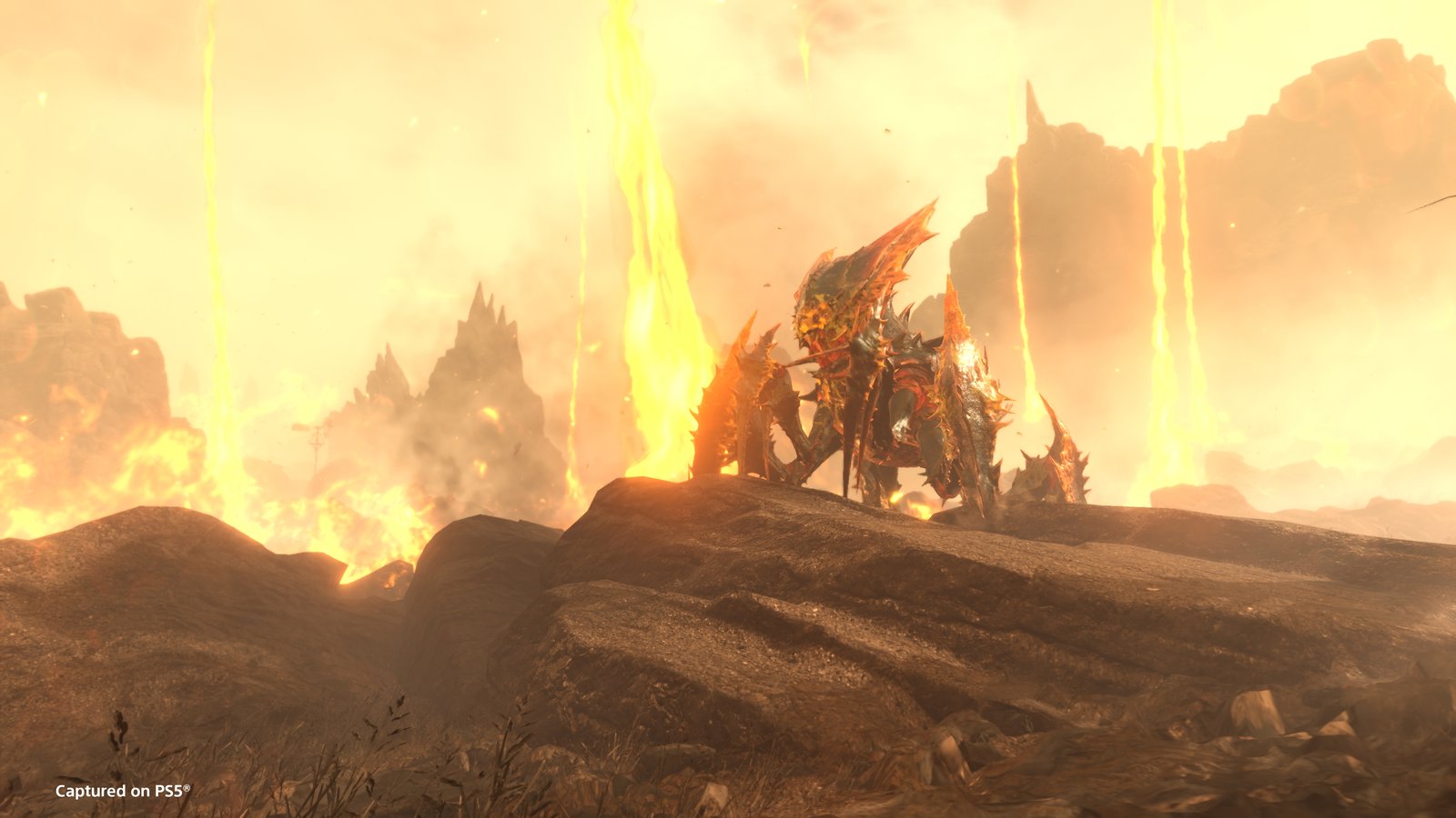 An Alpha Commander, a large spiked Terminid, stands on a rock in a volcanic landscape with falls of lava behind it